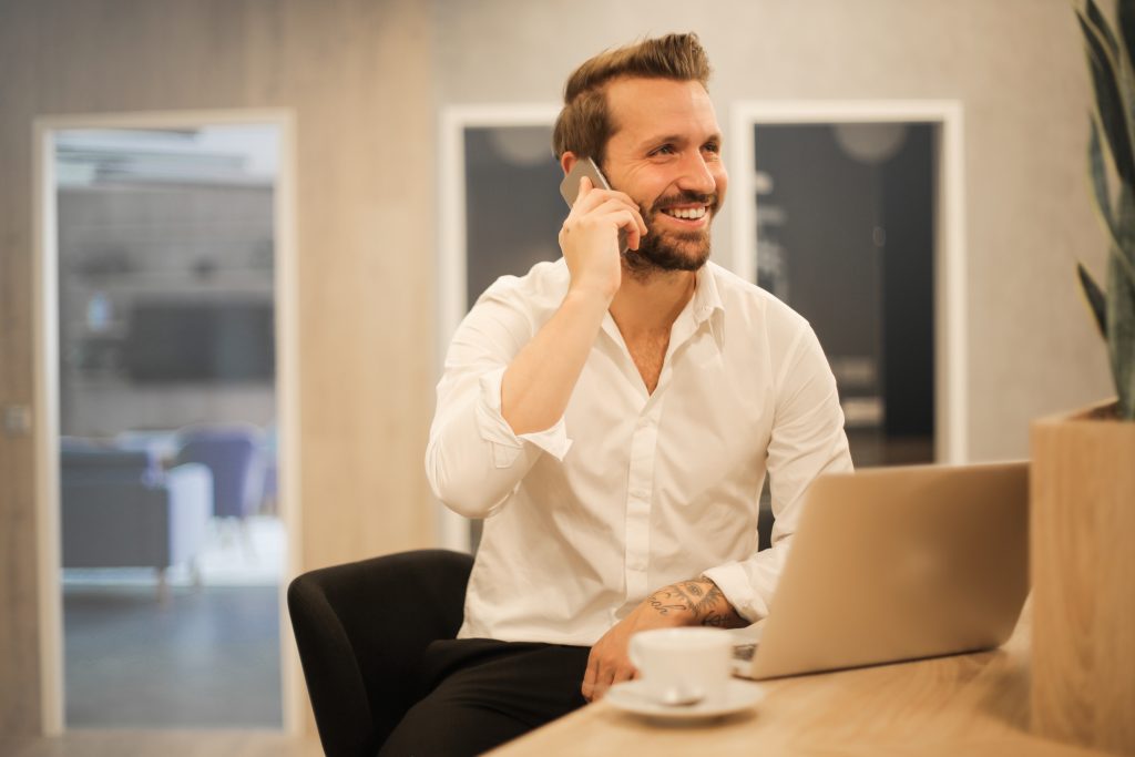proactive it maintenance plan - man talking and smiling on the phone