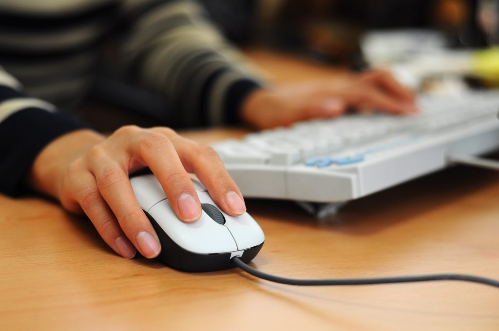 IT services provider Brisbane woman using keyboard and mouse