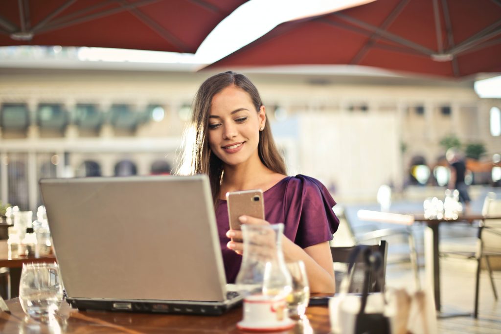 IT support services - woman smiling at mobile phone