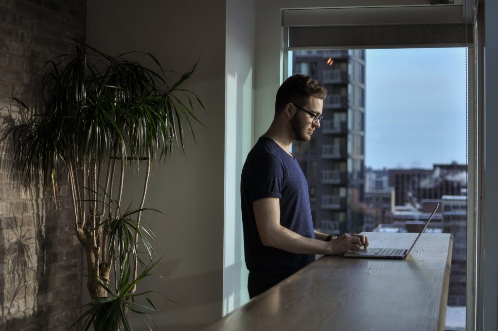 Cloud Backup Solutions - man using laptop at counter
